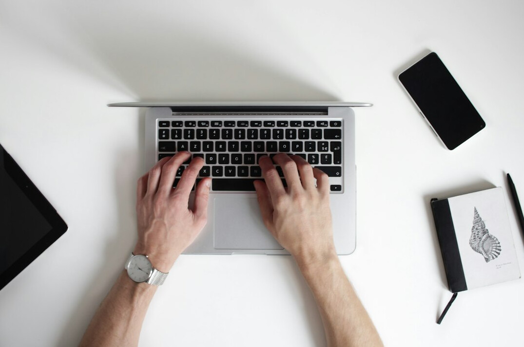 writer typing on laptop